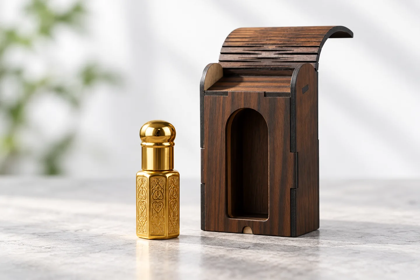 Sirat 6ml gold roll-on attar beside an empty wooden presentation box